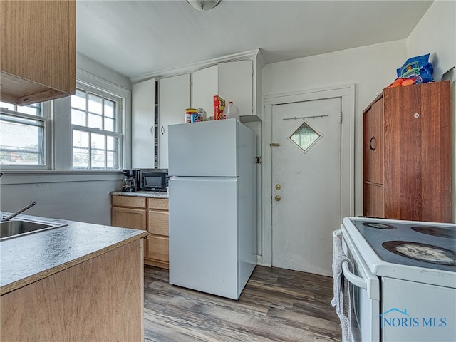 kitchen with wood-type flooring, white appliances, and sink