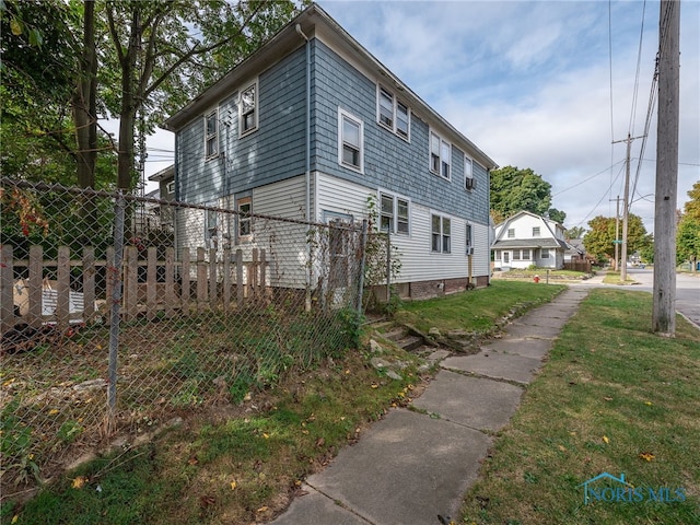 view of side of home featuring a yard