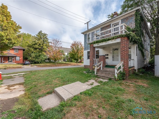 exterior space featuring a front lawn and a porch