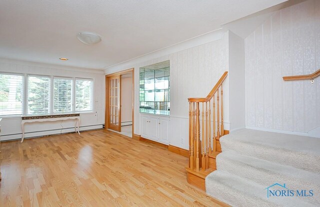 foyer featuring light hardwood / wood-style flooring and a baseboard heating unit