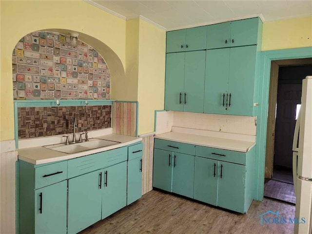 kitchen with crown molding, white fridge, dark wood-type flooring, and green cabinetry