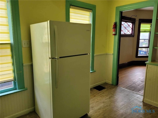 kitchen featuring white fridge and wood-type flooring