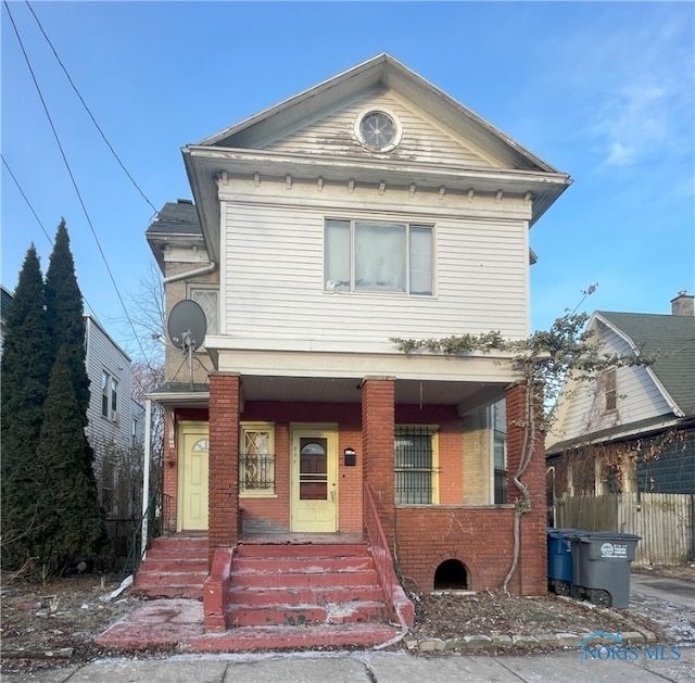 view of front facade with a porch and brick siding