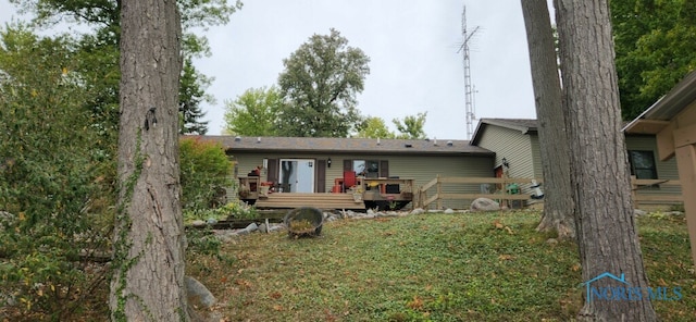 back of house featuring a wooden deck