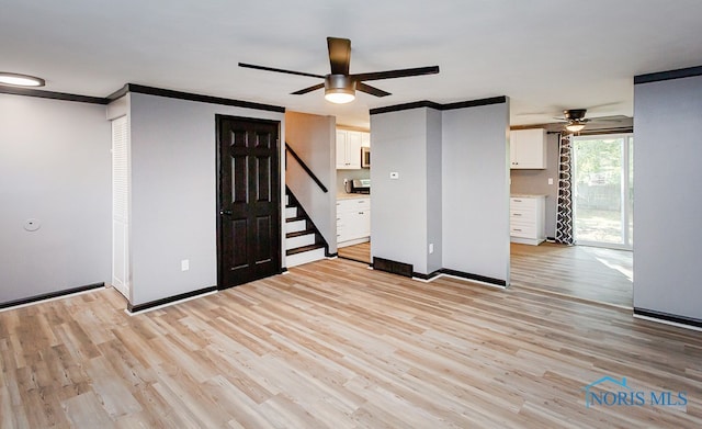 interior space with light hardwood / wood-style flooring, ceiling fan, and crown molding