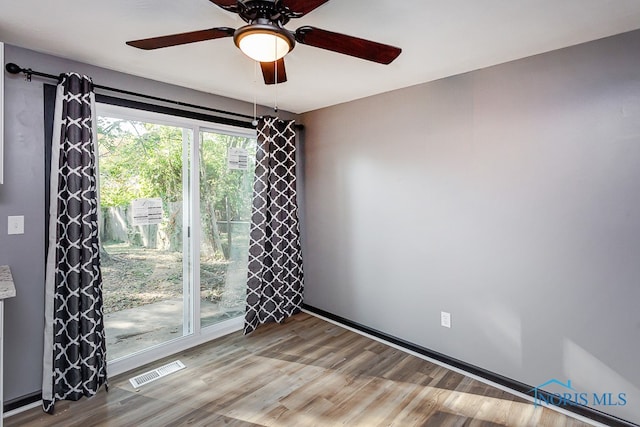 unfurnished room featuring light wood-type flooring and ceiling fan