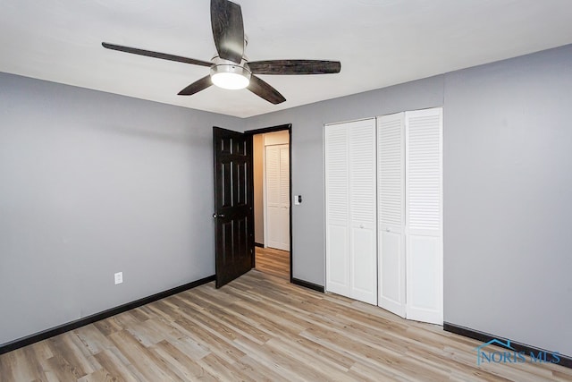 unfurnished bedroom with light hardwood / wood-style floors, ceiling fan, and a closet