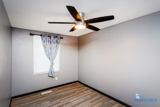 spare room featuring ceiling fan and hardwood / wood-style flooring