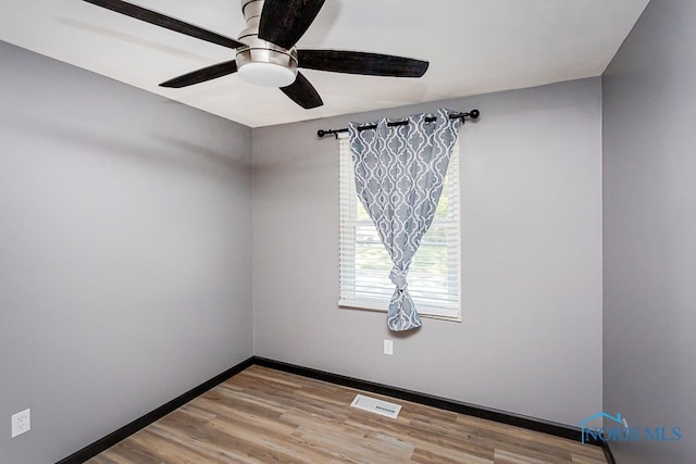 empty room featuring ceiling fan and wood-type flooring