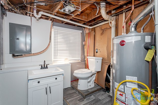 bathroom with water heater, electric panel, vanity, wood-type flooring, and toilet