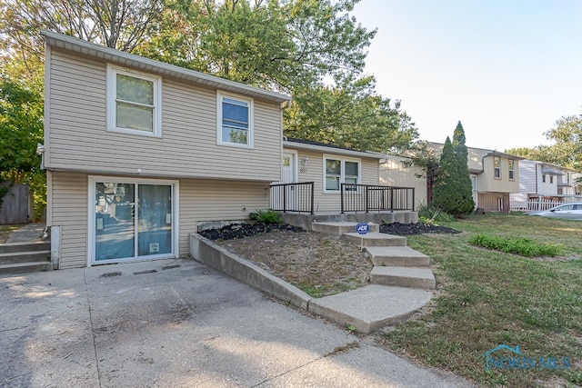 view of front of house with a deck and a front lawn