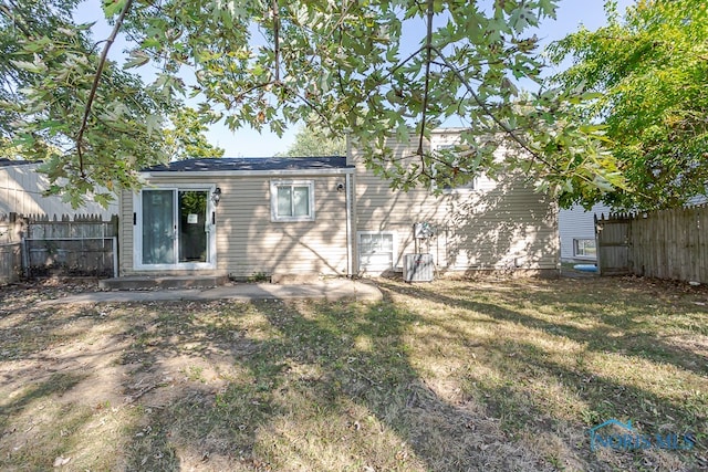 back of house with a lawn