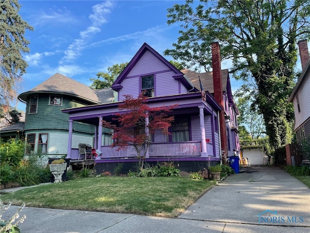 victorian-style house with a front lawn and covered porch