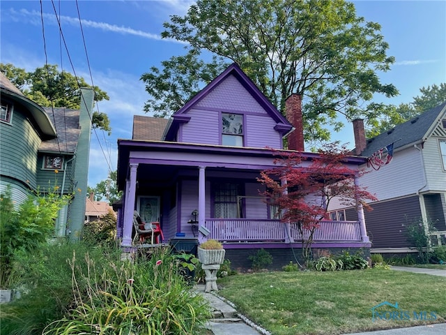 630 Acklin Ave, Toledo, OH 43620 - view of front facade featuring a front lawn and covered porch