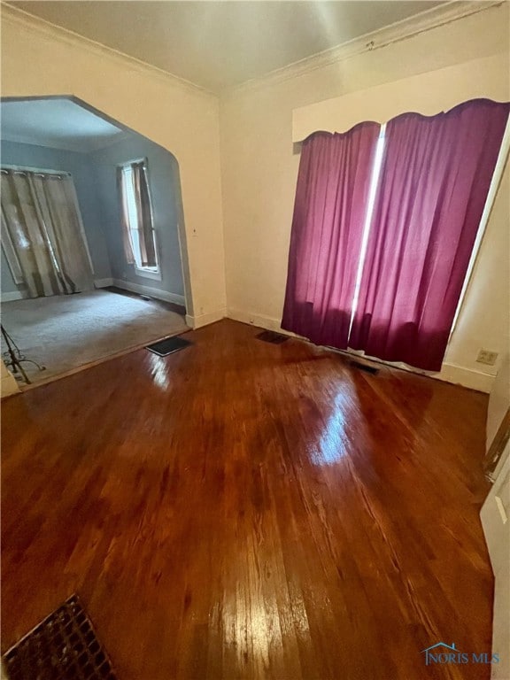 unfurnished room with crown molding and hardwood / wood-style floors