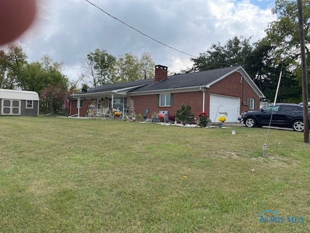 view of front of property with a garage, an outdoor structure, a porch, and a front lawn