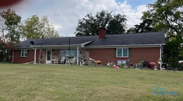 rear view of house with a lawn