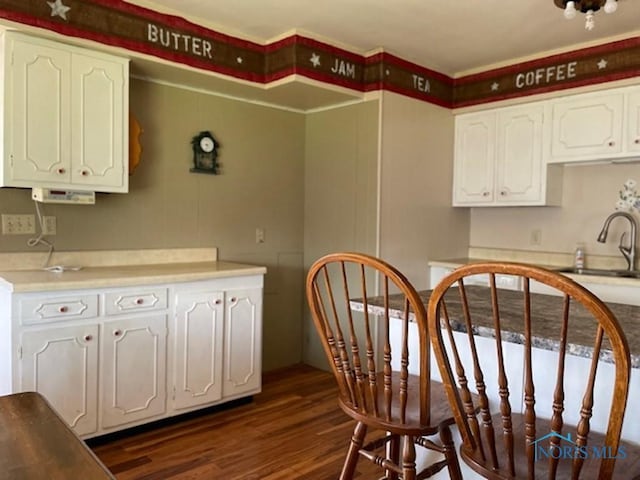 kitchen featuring white cabinetry, sink, and dark hardwood / wood-style floors