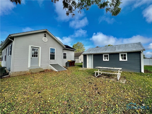 rear view of property featuring a yard