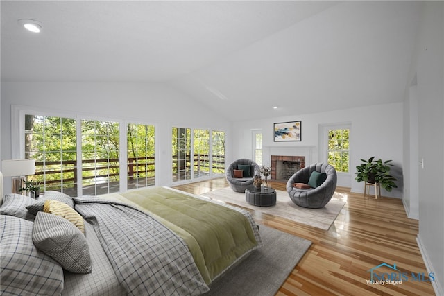 bedroom featuring light wood-type flooring and vaulted ceiling