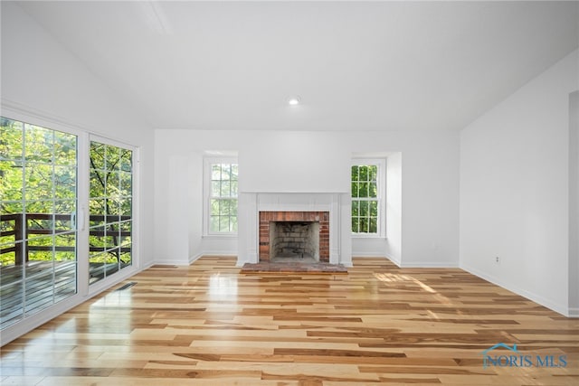 unfurnished living room with light hardwood / wood-style flooring and a healthy amount of sunlight