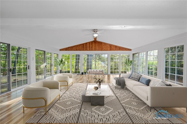 sunroom with lofted ceiling with beams and ceiling fan