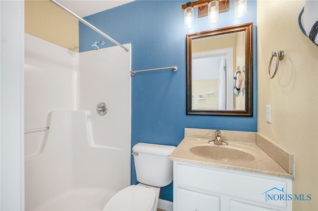 bathroom featuring a shower, vanity, and toilet