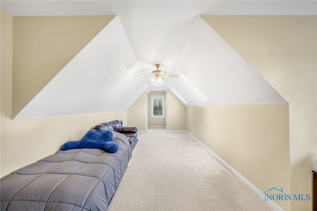 carpeted bedroom featuring ceiling fan and lofted ceiling with skylight