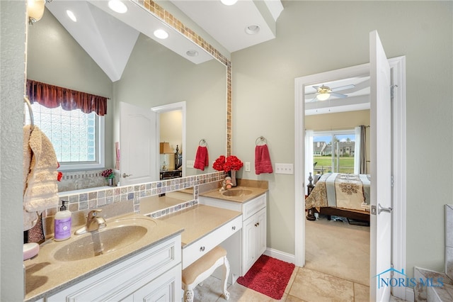 bathroom featuring tile patterned flooring, lofted ceiling, vanity, and ceiling fan