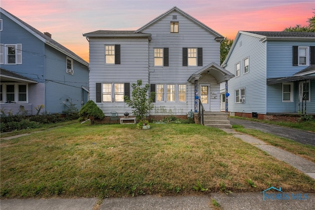 view of front of house with a yard