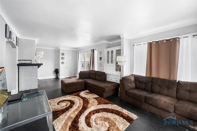 living room with an inviting chandelier, dark hardwood / wood-style floors, and crown molding