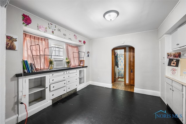 kitchen with cooling unit, dark hardwood / wood-style floors, and white cabinets