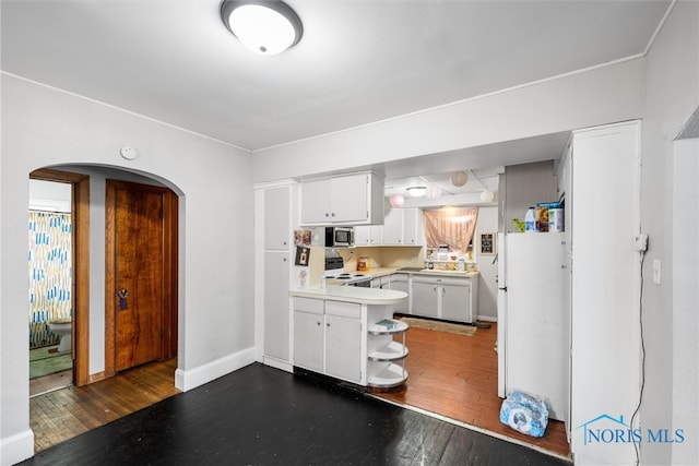 kitchen with white cabinets, dark wood-type flooring, and electric range