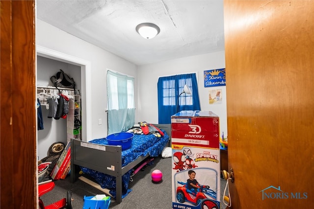 carpeted bedroom featuring a closet