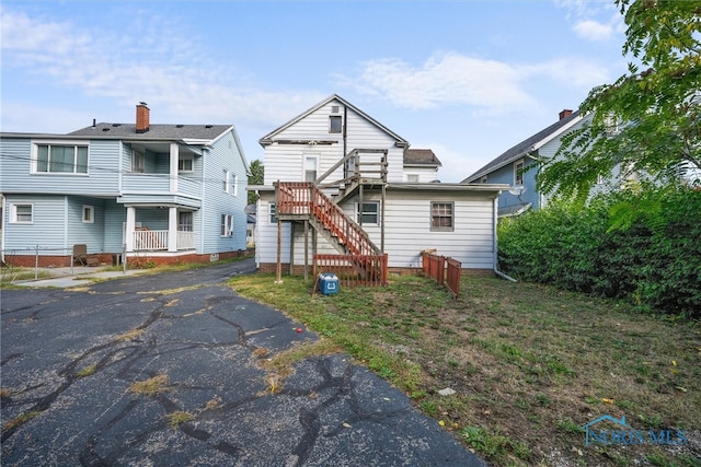 rear view of house featuring a balcony