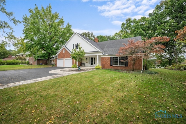 view of front of house featuring a garage and a front lawn