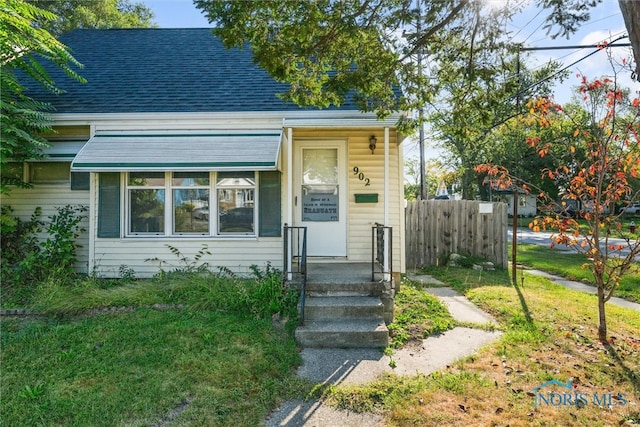 bungalow-style home with a front yard