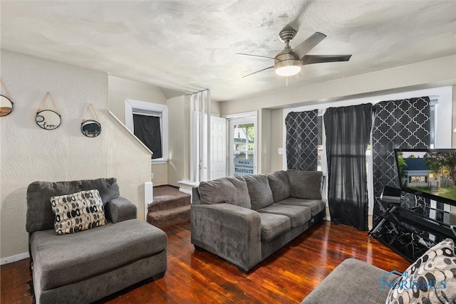 living room with dark hardwood / wood-style flooring and ceiling fan