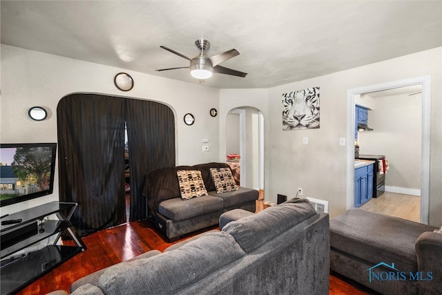 living room with ceiling fan and hardwood / wood-style flooring