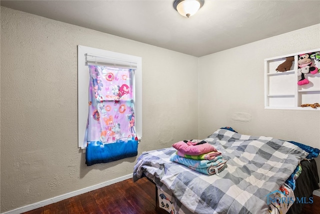 bedroom with hardwood / wood-style floors