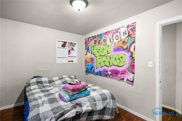 bedroom with dark wood-type flooring