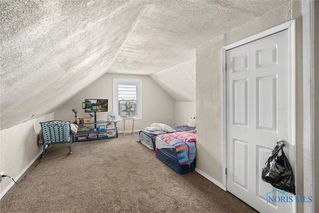 bedroom with lofted ceiling, carpet, and a textured ceiling