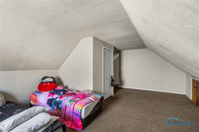 carpeted bedroom featuring vaulted ceiling and a textured ceiling