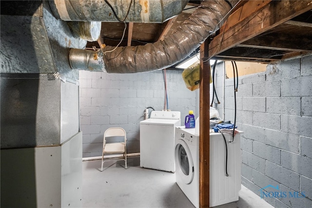 washroom featuring heating unit and washer and dryer