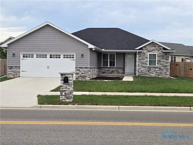 view of front of house with a garage and a front lawn