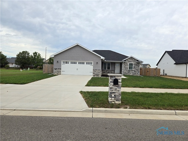 view of front of house featuring a garage and a front lawn