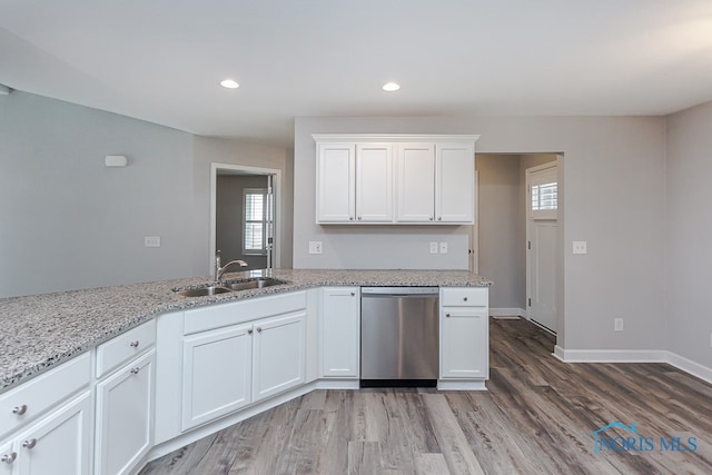 kitchen with dishwasher, plenty of natural light, and light hardwood / wood-style floors