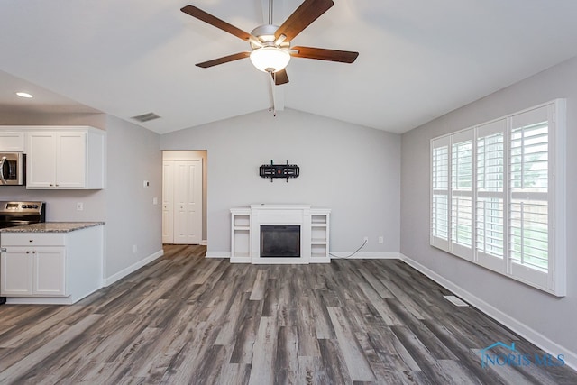 unfurnished living room featuring ceiling fan, lofted ceiling, and dark wood-type flooring