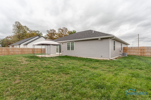 rear view of property featuring a patio, a gazebo, a lawn, and central air condition unit