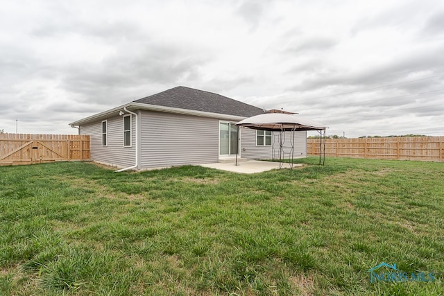 back of property featuring a yard and a patio area